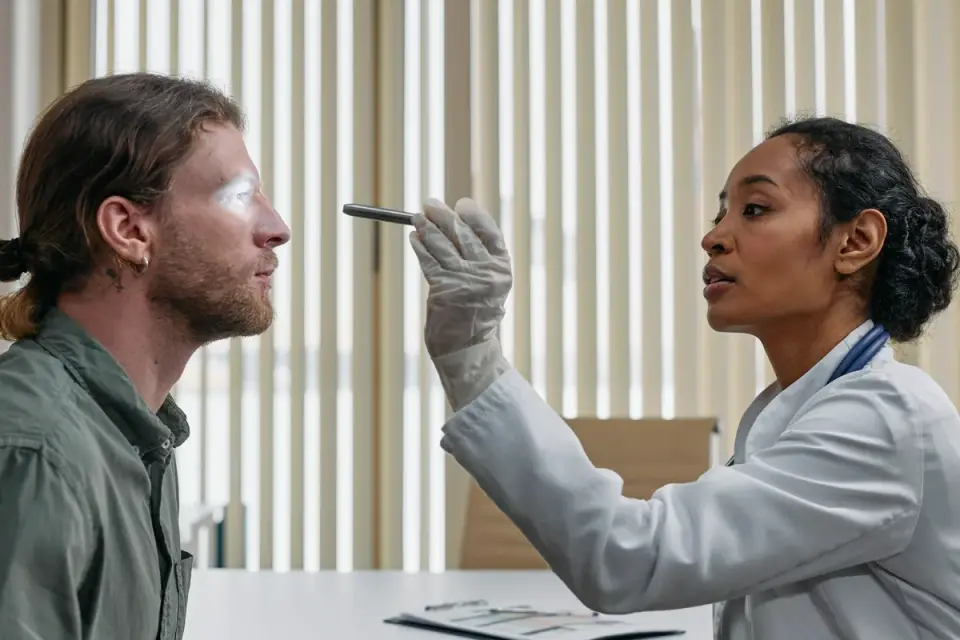 A veterinarian gently examining an older dog on an exam table