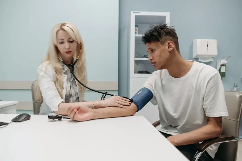 A veterinarian gently examining a nervous dog during a checkup