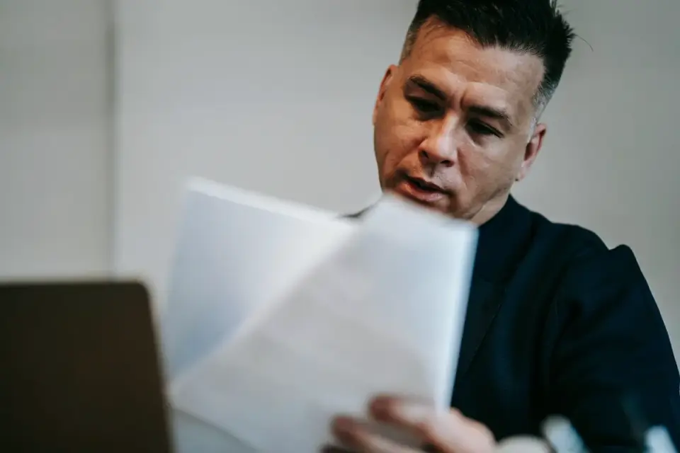 A veterinarian reviewing a printed certificate of analysis next to a supplement bottle
