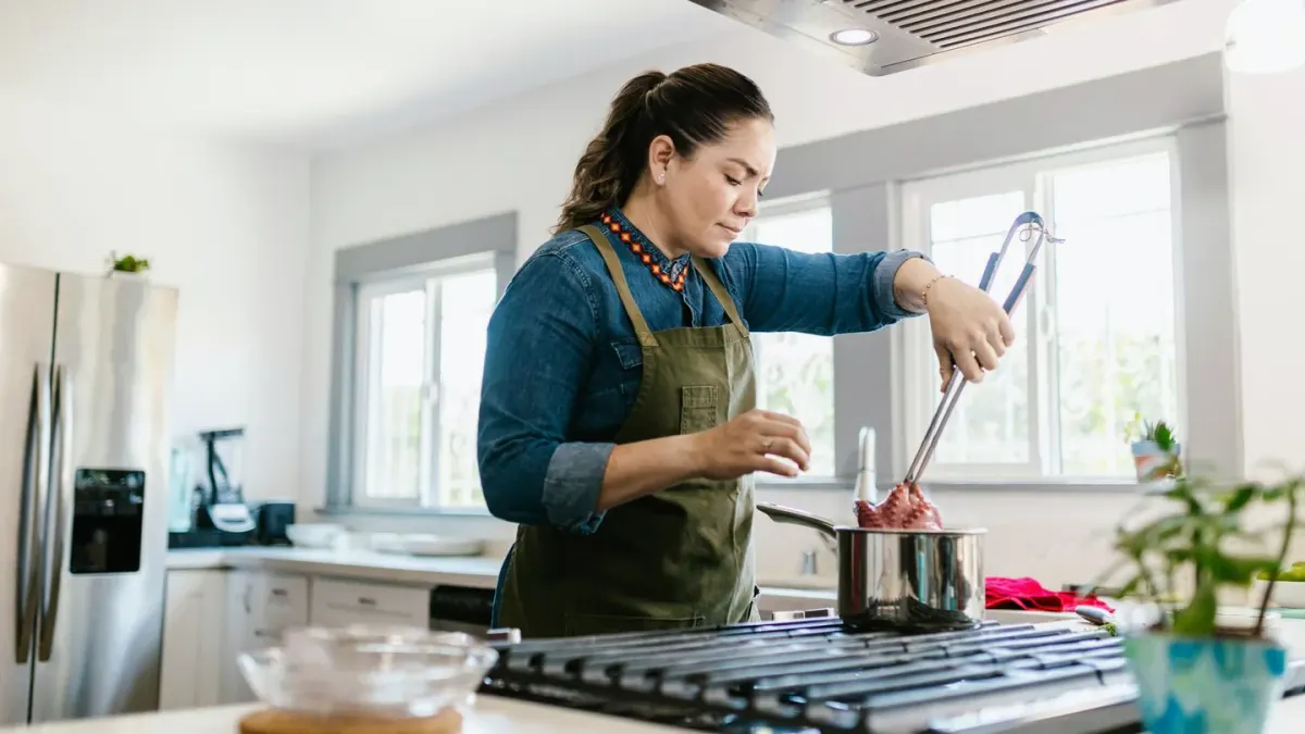Dog owner preparing dog food kitchen
