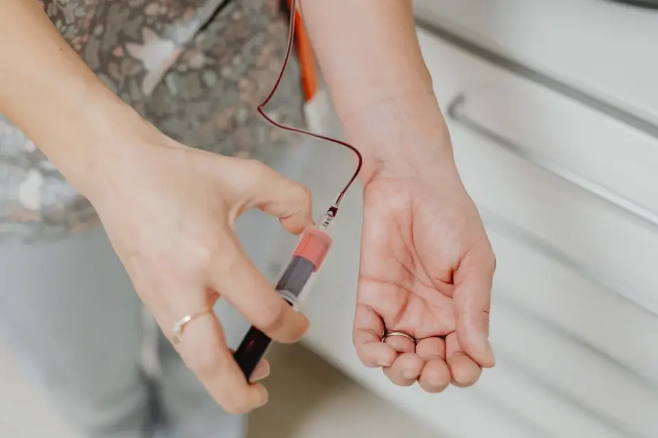 Veterinarian drawing a blood sample from a senior dog&#x27;s foreleg