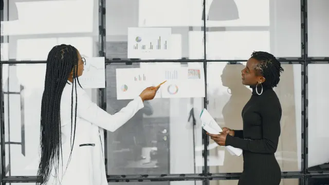 Veterinarian pointing at a lab results printout while a dog sits on the exam table